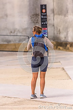 View of back of woman tourist waiting in the historic area of â€‹â€‹Coimbra, Portugal Editorial Stock Photo